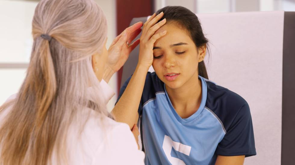 A young soccer player with a head injury at physiotherapist
